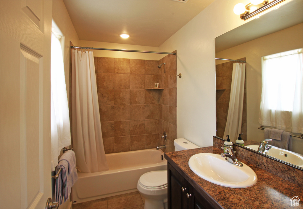 Full bathroom with toilet, tile floors, shower / tub combo with curtain, and oversized vanity