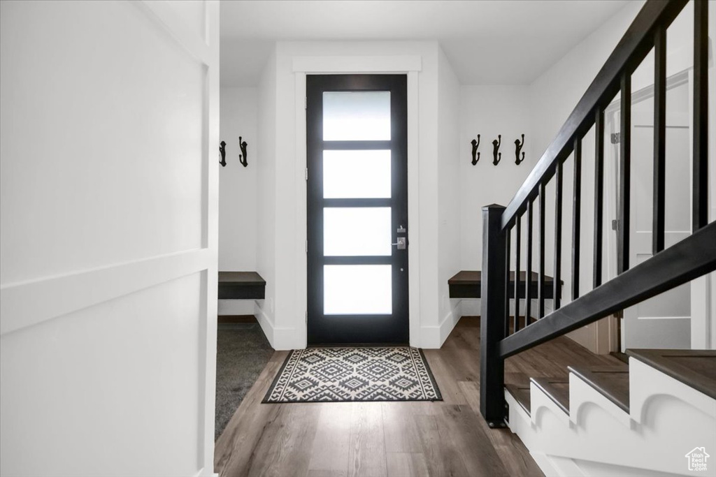 Entrance foyer with dark hardwood / wood-style floors