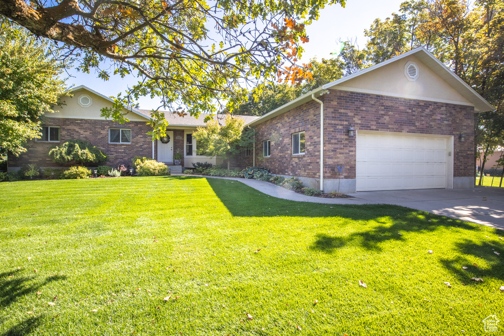 Ranch-style home with a front lawn