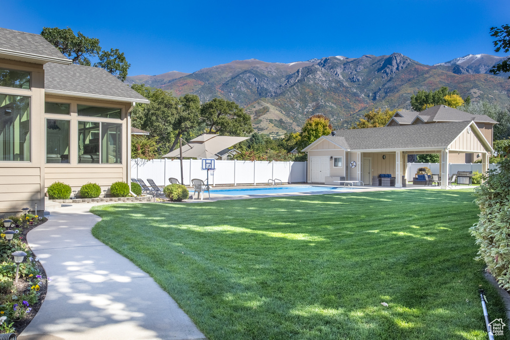 Exterior space featuring a patio area, a mountain view, and a fenced in pool