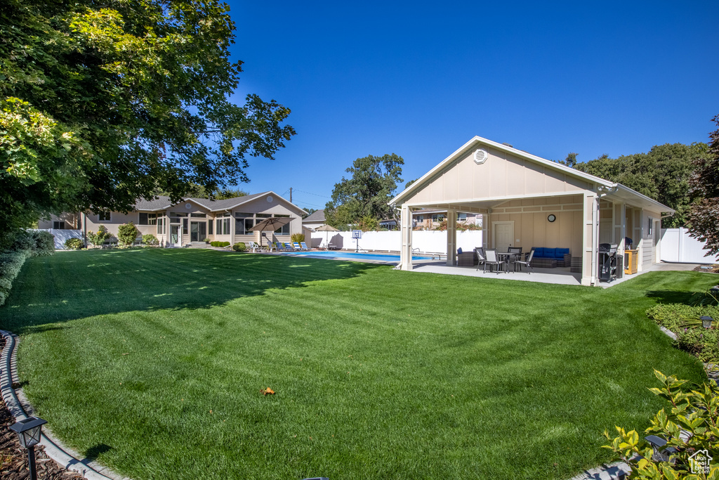 View of yard featuring a patio and a fenced in pool