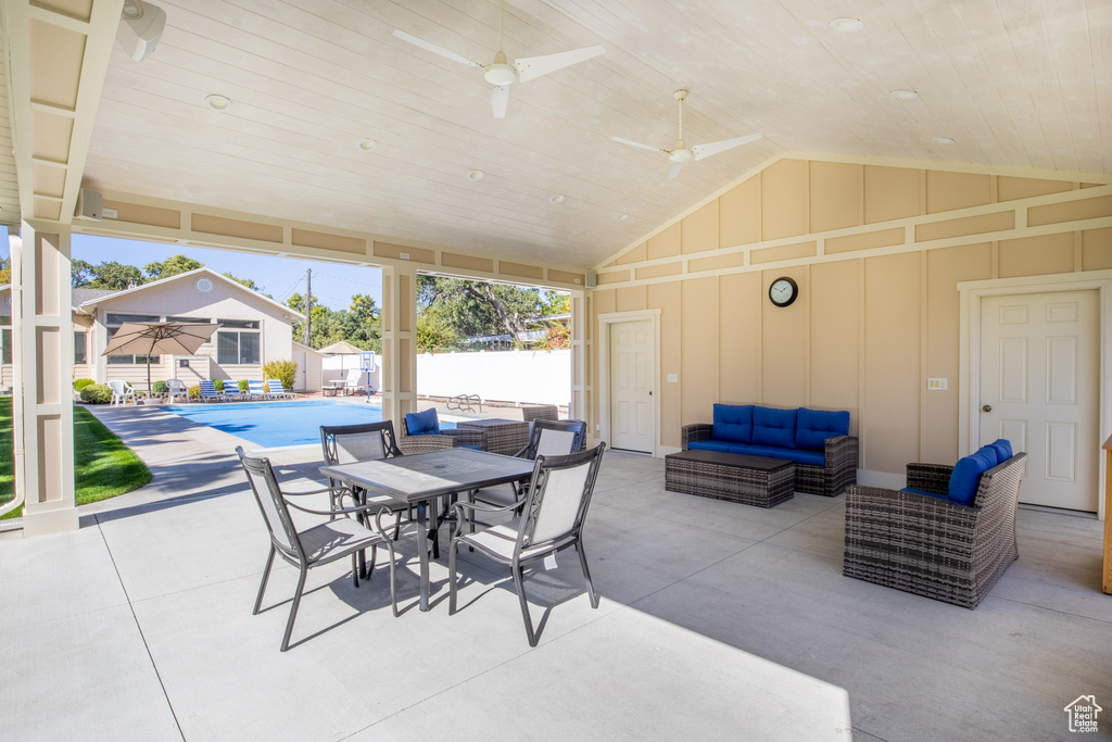 View of patio / terrace with a fenced in pool, ceiling fan, and an outdoor living space