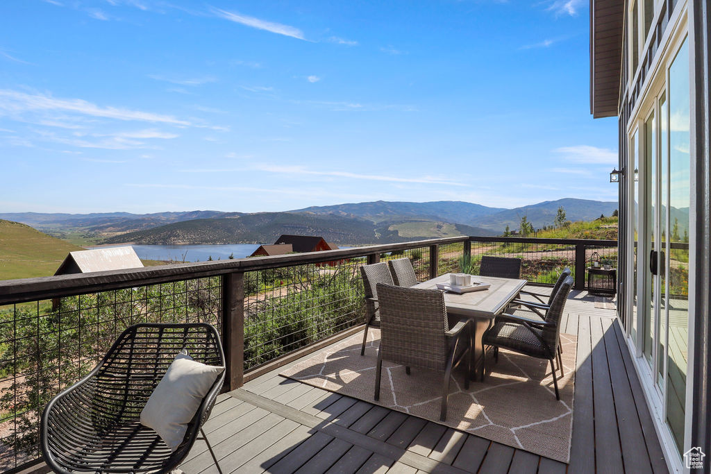 Deck with a water and mountain view