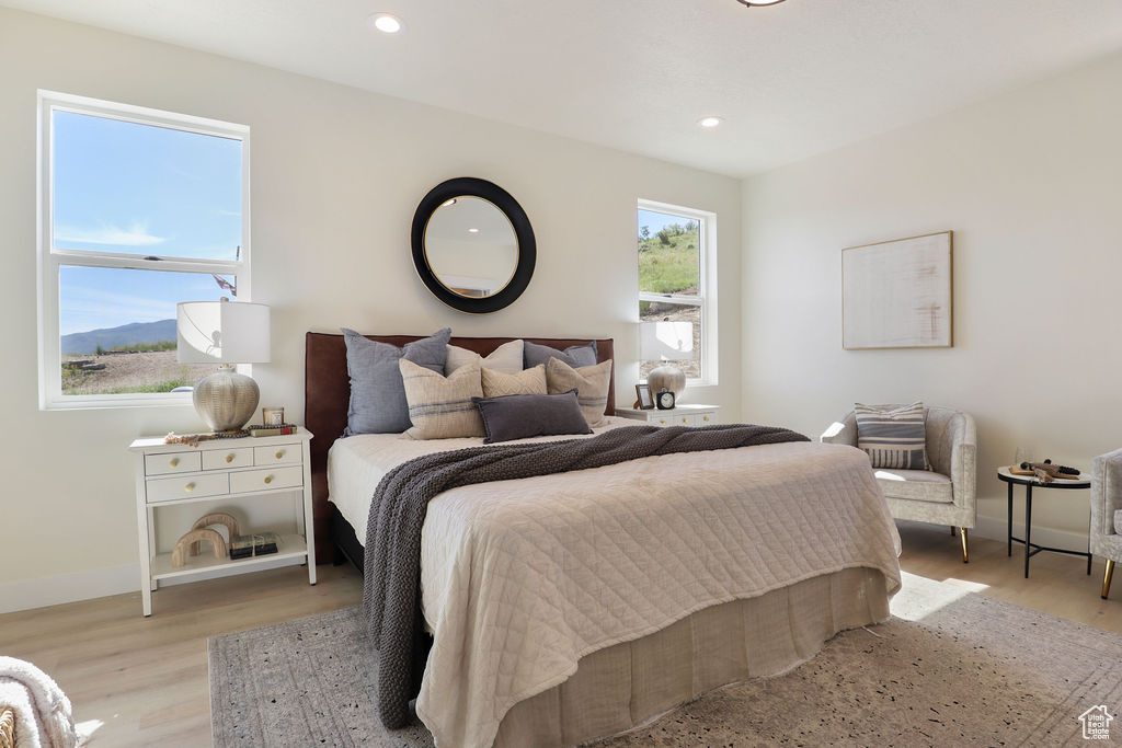 Bedroom with light hardwood / wood-style flooring