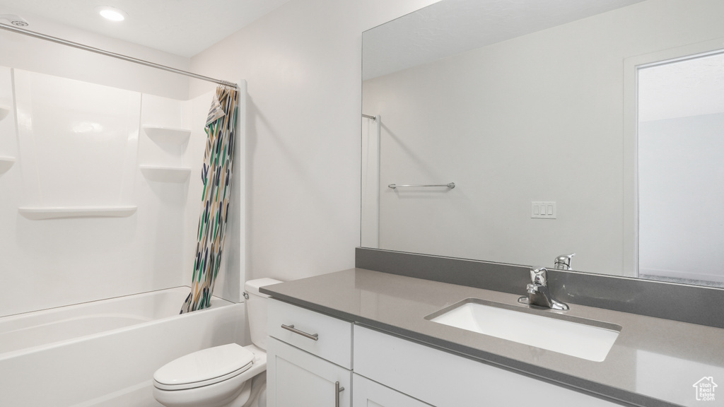 Full bathroom with shower / bathtub combination with curtain, toilet, and oversized vanity