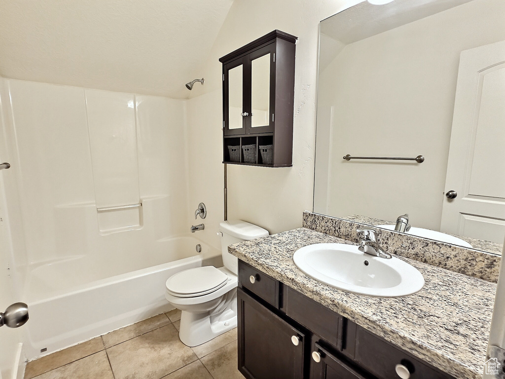 Full bathroom with shower / bathing tub combination, toilet, tile flooring, and vanity with extensive cabinet space