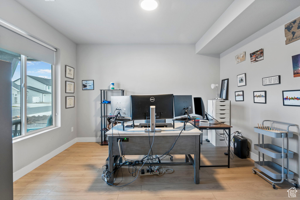 Home office featuring plenty of natural light and light hardwood / wood-style flooring