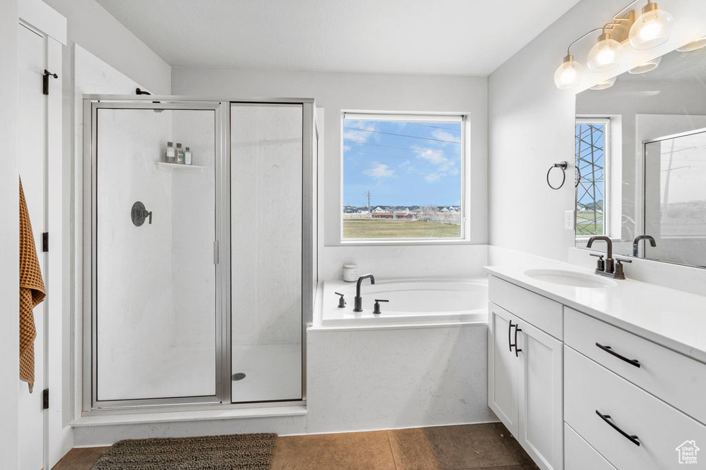 Bathroom with plus walk in shower, tile floors, and vanity with extensive cabinet space