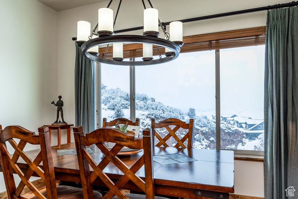 Dining room with an inviting chandelier, a wealth of natural light, and a mountain view