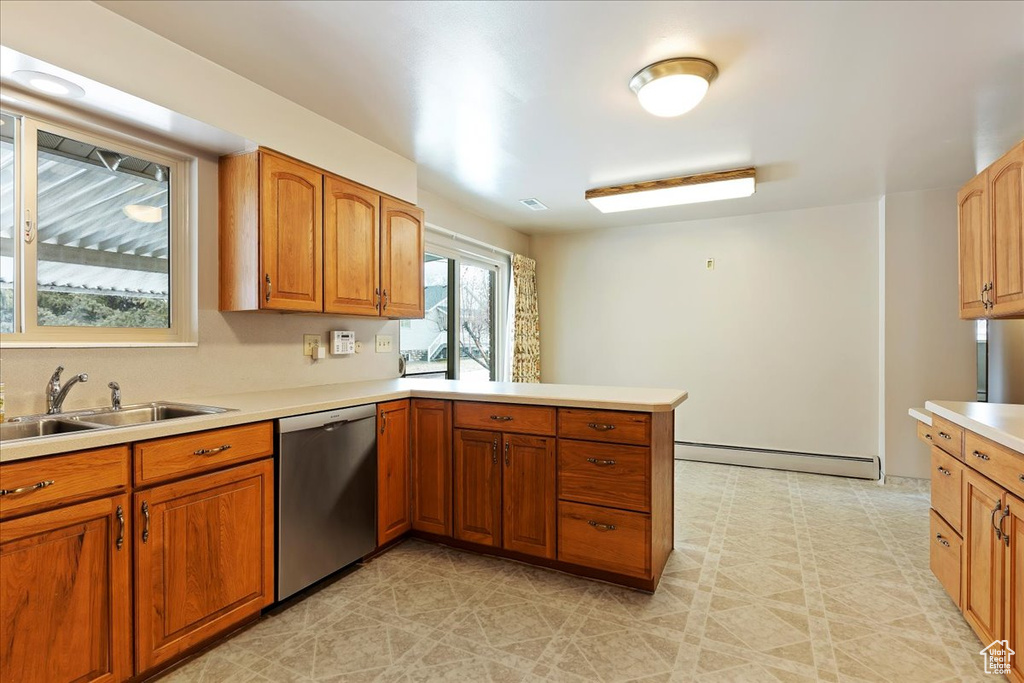 Kitchen with a baseboard heating unit, sink, dishwasher, and light tile floors