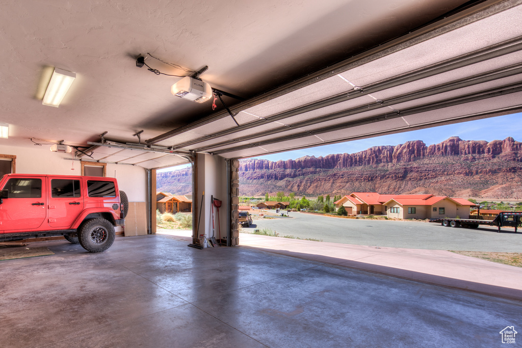 Garage with a mountain view and a garage door opener