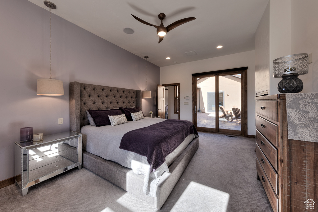 Carpeted bedroom featuring ceiling fan and access to exterior