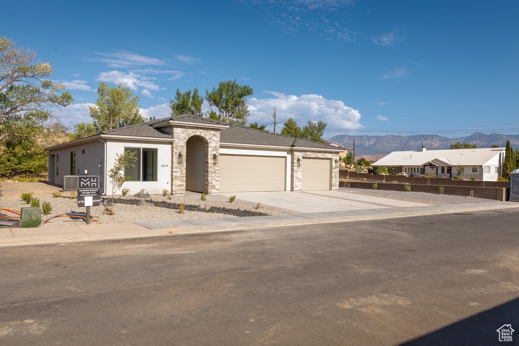 View of front facade featuring a mountain view and a garage