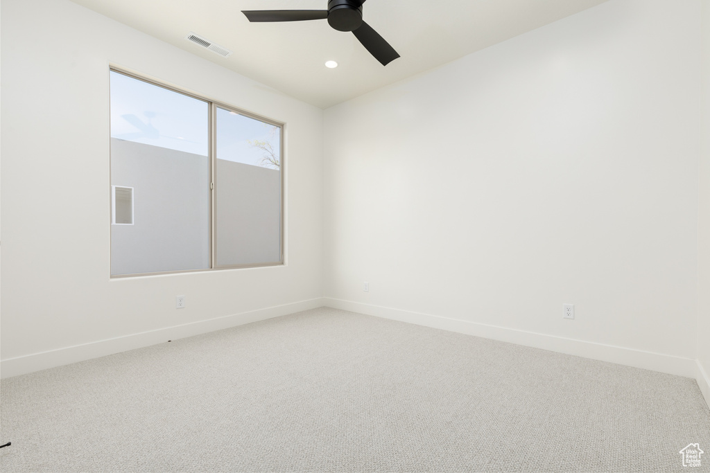 Unfurnished room with ceiling fan and carpet floors