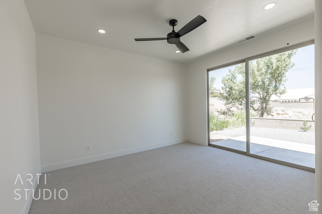 Empty room featuring ceiling fan and carpet