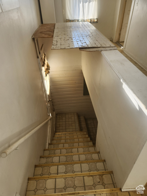 Stairs featuring tile flooring