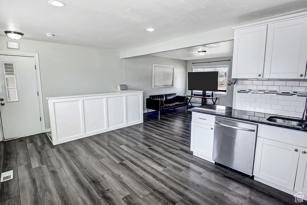 Kitchen featuring stainless steel dishwasher, dark hardwood / wood-style flooring, and white cabinetry