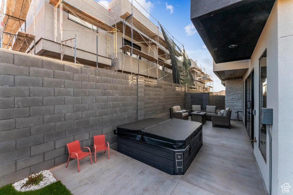 View of patio / terrace with outdoor lounge area and a hot tub