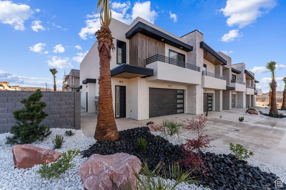 Contemporary house with a garage and a balcony