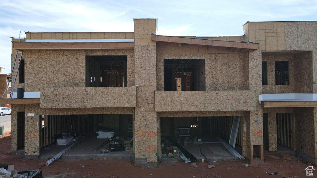 Back of house with a balcony