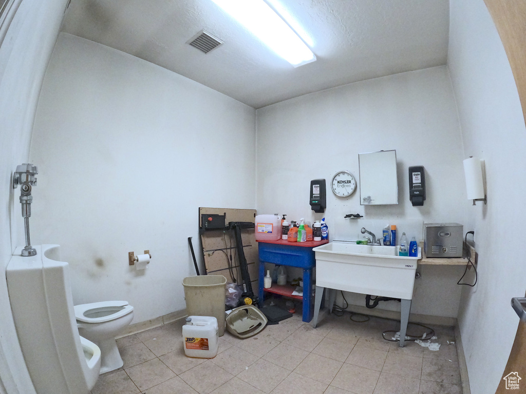 Bathroom featuring tile flooring, a bidet, and toilet