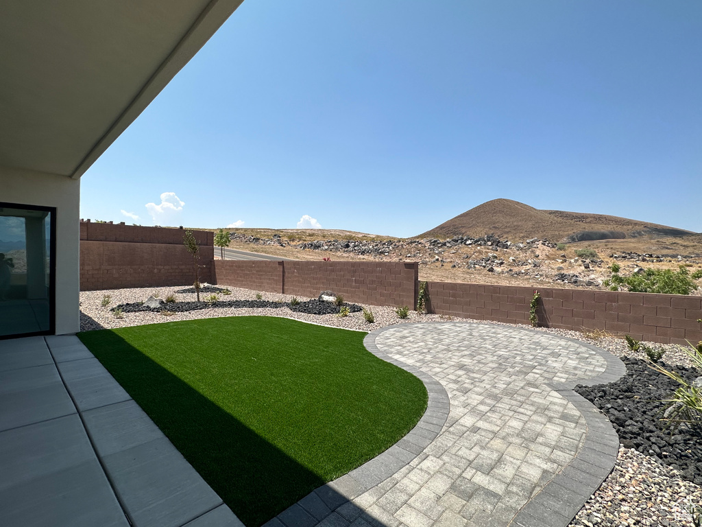 View of yard with a mountain view and a patio area