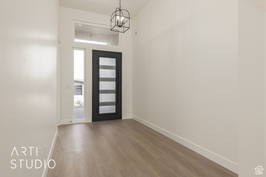 Entryway featuring a notable chandelier and dark hardwood / wood-style flooring