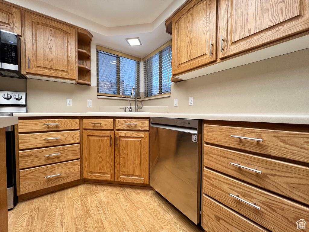 Kitchen featuring light hardwood / wood-style flooring and stainless steel appliances