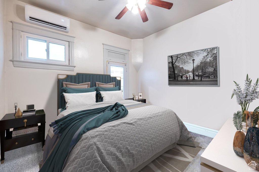 Bedroom with carpet floors, an AC wall unit, and ceiling fan