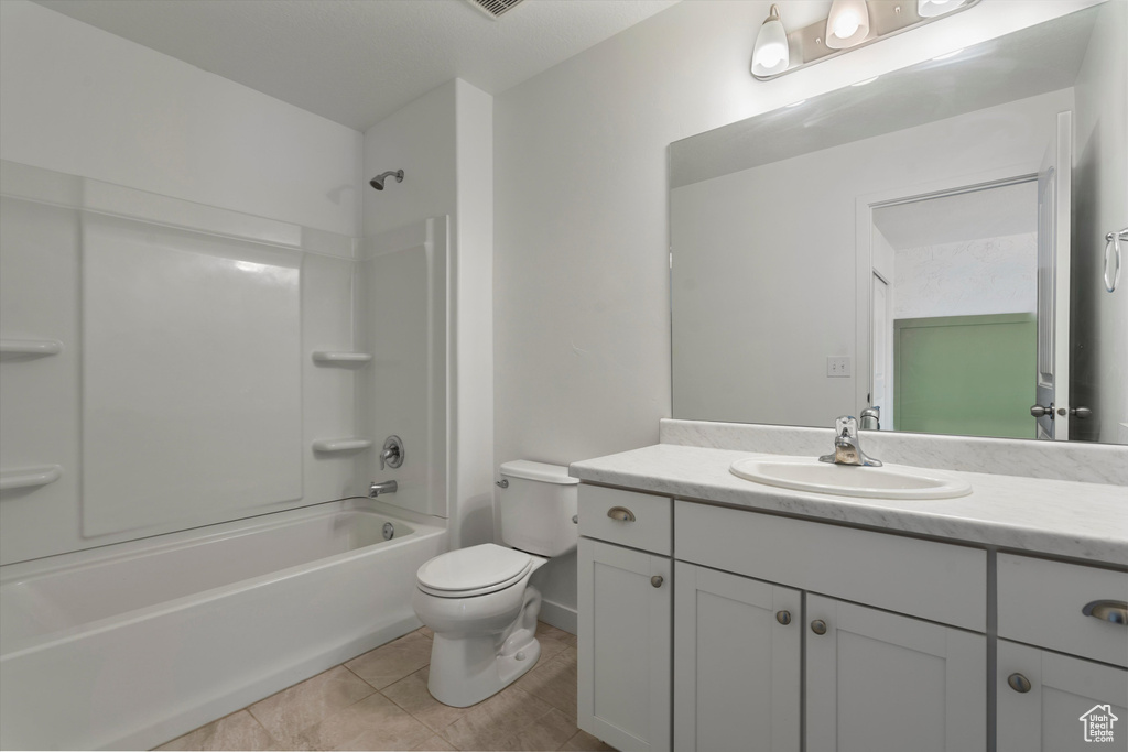 Full bathroom with vanity, toilet, shower / bath combination, and tile floors
