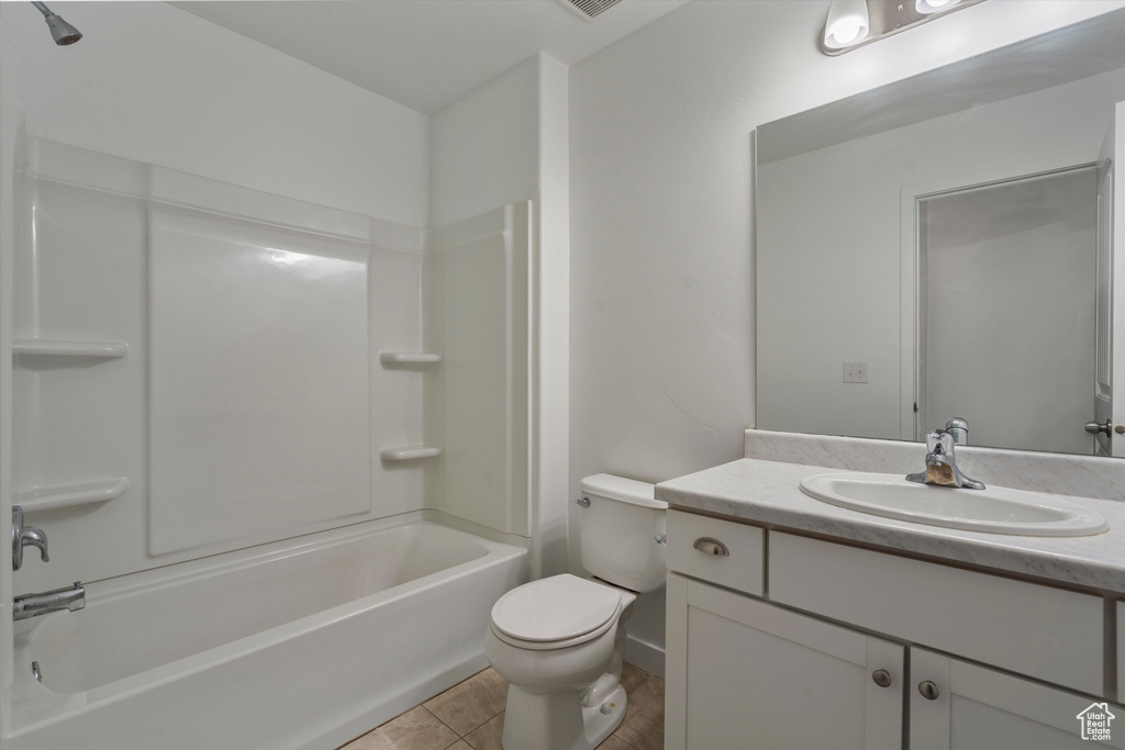 Full bathroom featuring vanity, shower / washtub combination, tile flooring, and toilet