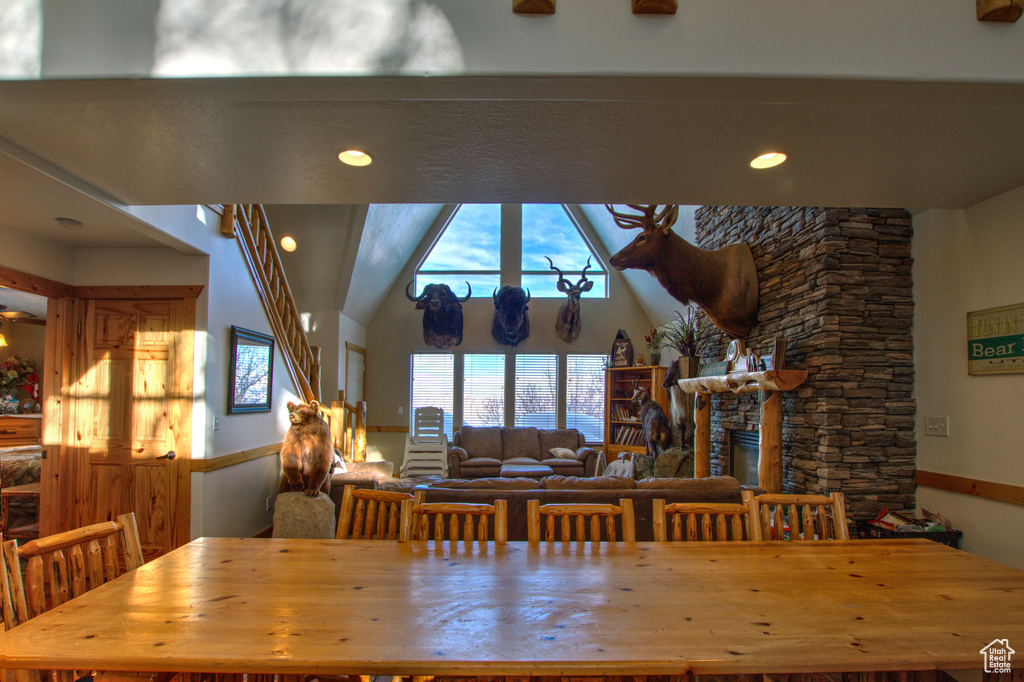 Dining space featuring a fireplace and vaulted ceiling