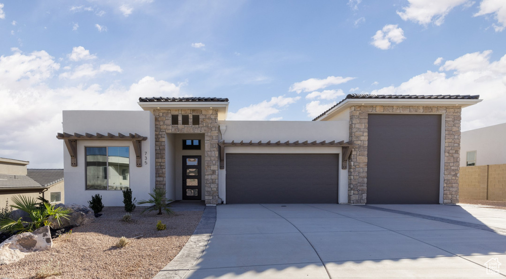 Mediterranean / spanish-style house featuring a garage