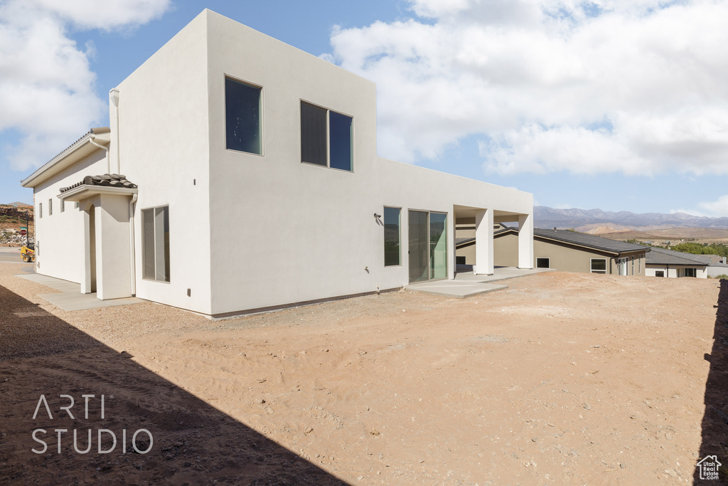 Back of property with a mountain view