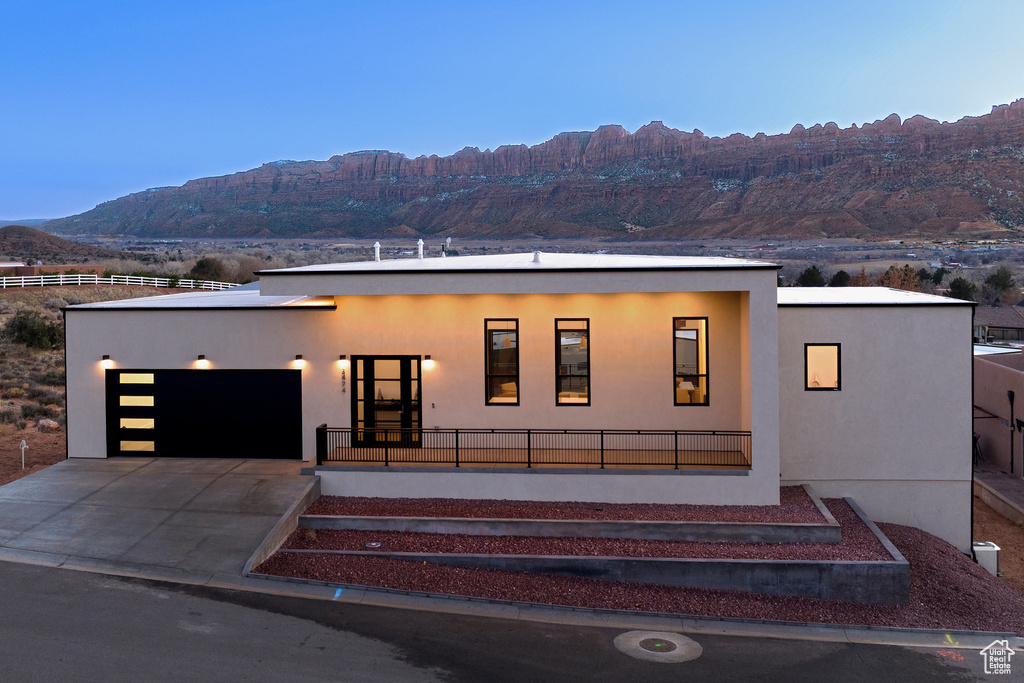 View of front of house featuring a garage and a mountain view
