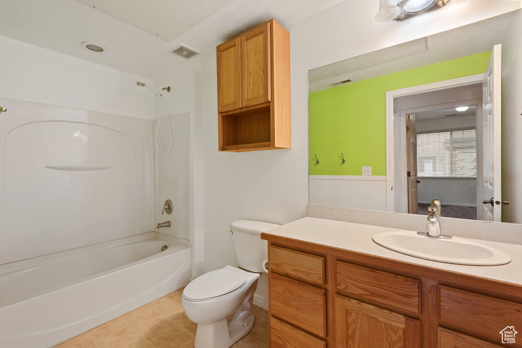 Full bathroom with oversized vanity, french doors, toilet,  shower combination, and tile flooring