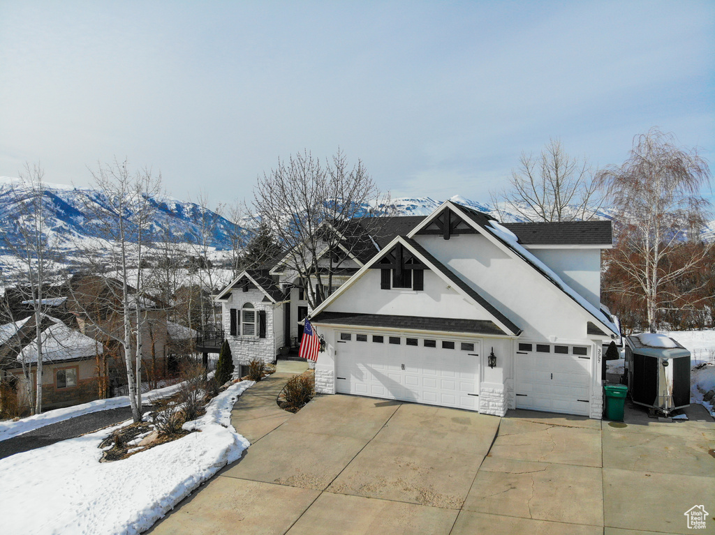 View of property featuring a garage and a mountain view