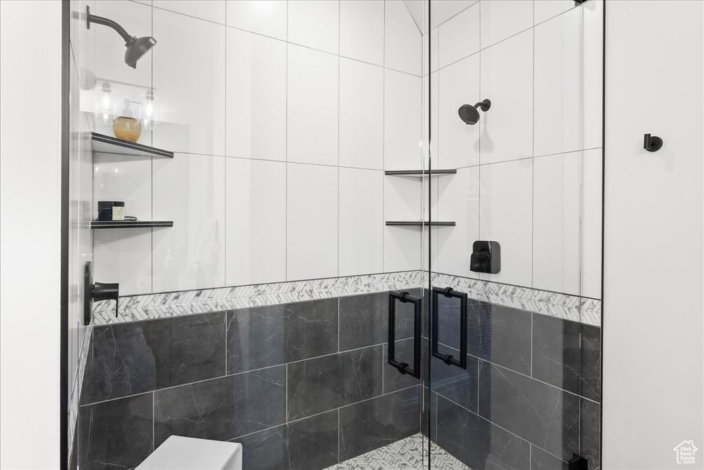 Bathroom with tile walls and an enclosed shower
