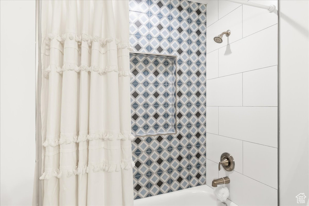 Bathroom featuring shower / bath combo with shower curtain