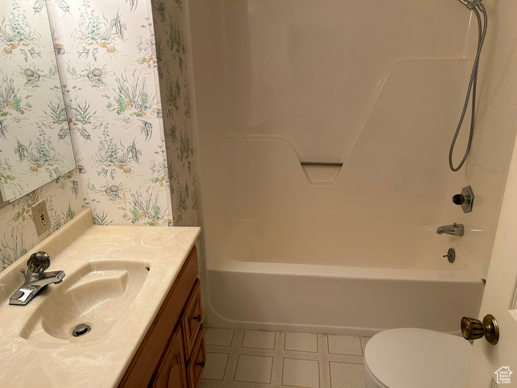 Full bathroom with tile flooring, oversized vanity, and  shower combination