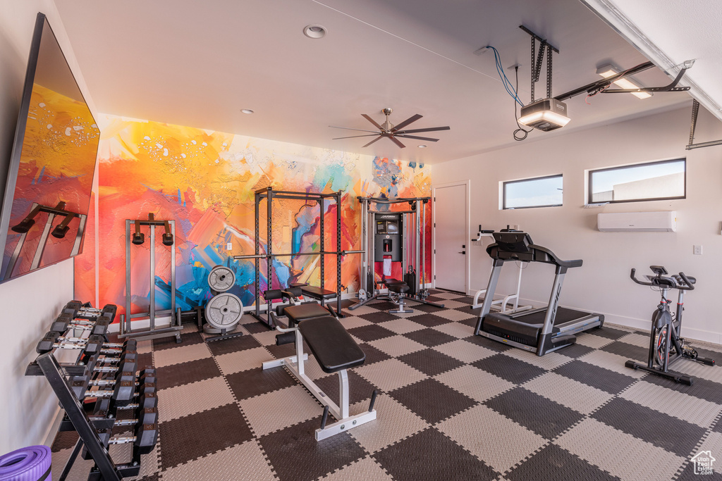 Workout area featuring ceiling fan and a wall mounted air conditioner