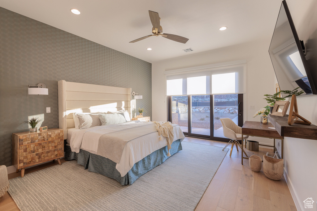 Bedroom with access to outside, ceiling fan, and light hardwood / wood-style flooring