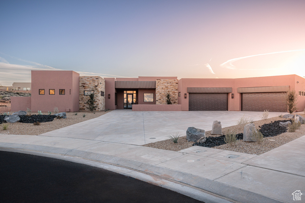 Pueblo revival-style home with a garage