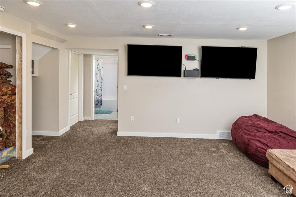 Interior space featuring dark colored carpet