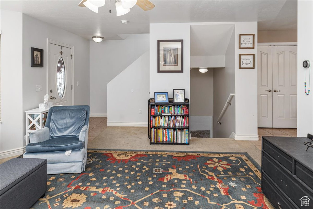 Sitting room with ceiling fan and light colored carpet