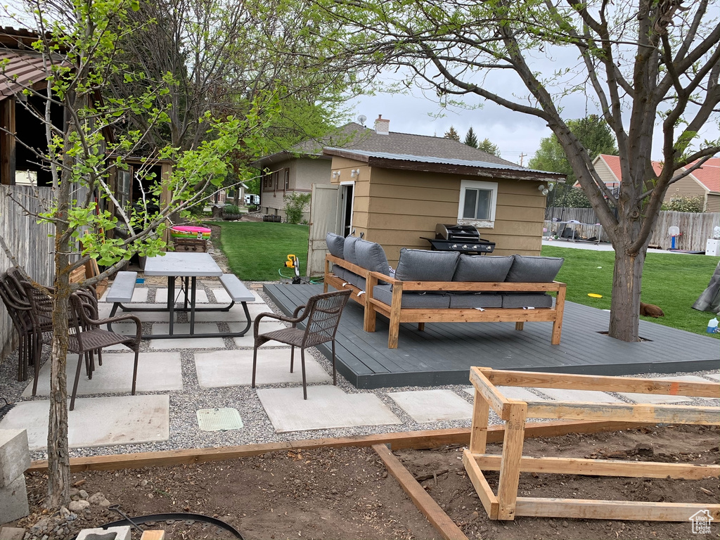 View of patio featuring a wooden deck and an outdoor hangout area