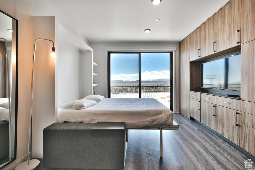Bedroom featuring hardwood / wood-style floors and access to exterior