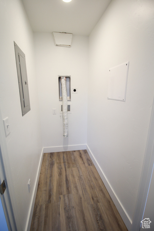 Washroom featuring dark wood-type flooring and hookup for an electric dryer