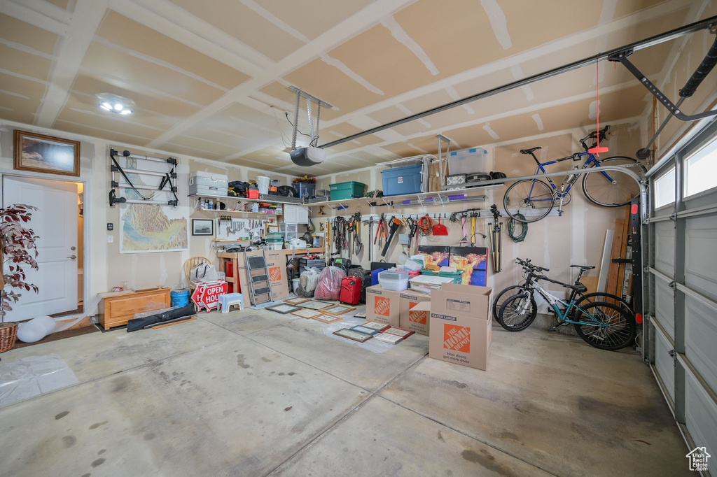 Garage featuring a garage door opener and a workshop area