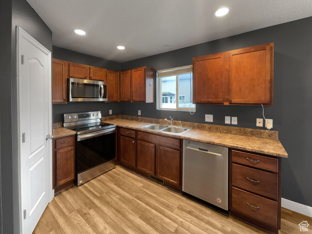 Kitchen featuring light hardwood / wood-style floors, sink, and stainless steel appliances